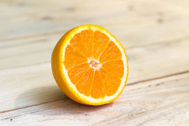 Composition of fresh ripe cut oranges on wooden background. Exot - Foto, imagen