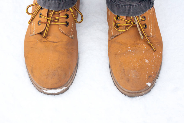 Brown shoes on snow top view - 写真・画像