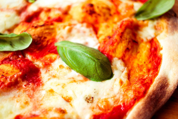 Pizzu se sýrem a kořením a listy bazalky  - Fotografie, Obrázek