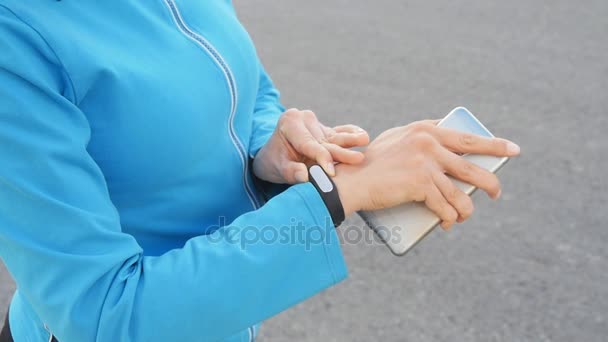 Woman looking at fitness tracker - Footage, Video