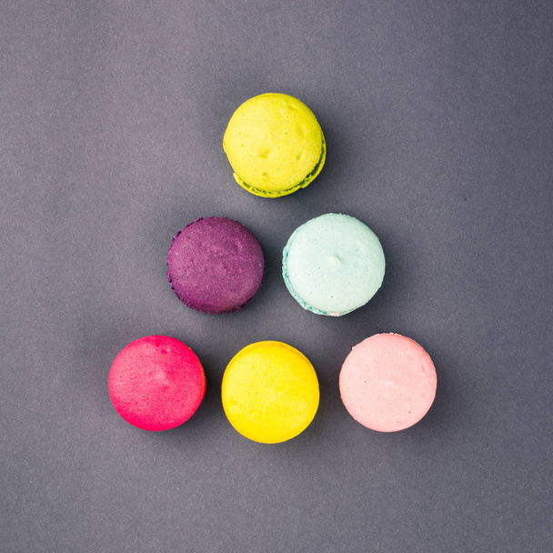 Colourful french macaroons on the grey background, Top view. Square - Photo, Image