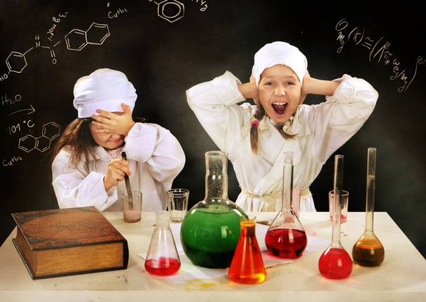 two girls - girlfriends playing in chemists - 写真・画像
