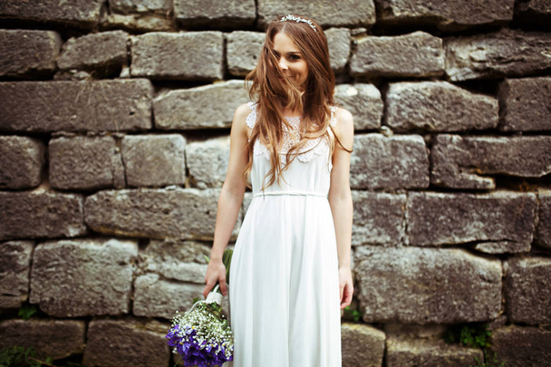 Bride looks stunning being half-hidden behind her hair  - Fotoğraf, Görsel