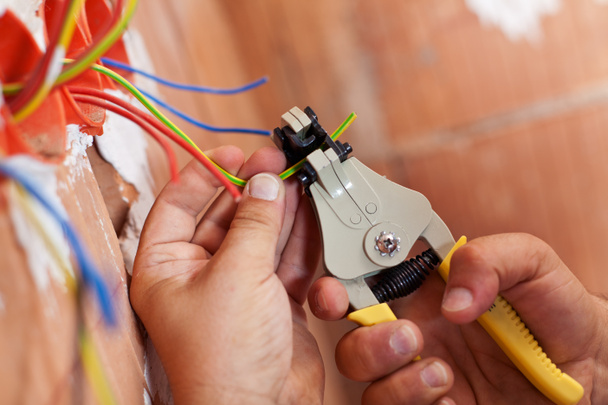 Electrician peeling off wires - Photo, Image