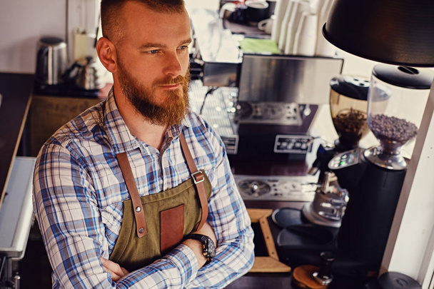Bearded coffee seller on his workplace - Fotografie, Obrázek