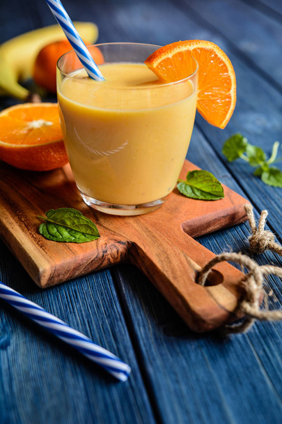 Fresh mandarin smoothie with banana and yoghurt            - Photo, Image