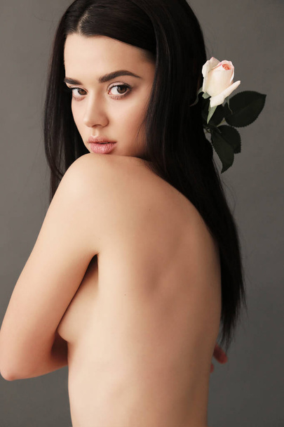 beautiful young girl with dark hair and glowing skin   - Foto, afbeelding
