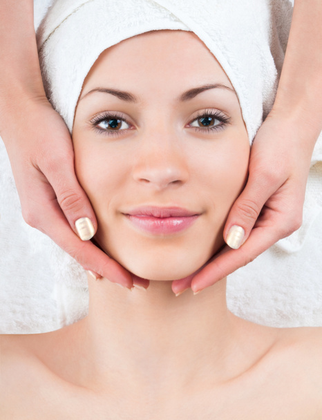 young woman enjoying facial massage in spa - Fotografie, Obrázek