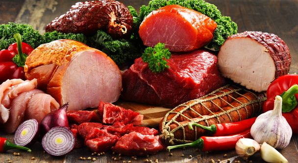 Variety of meat products including ham and sausages - Фото, изображение