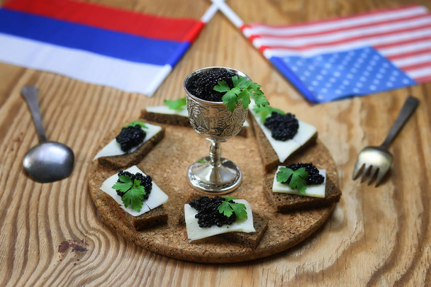 snack black caviar on wooden background - Photo, Image