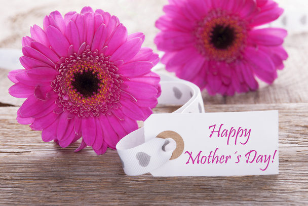 Vaaleanpunainen kevät Gerbera, etiketti, teksti onnellinen äitienpäivä
 - Valokuva, kuva