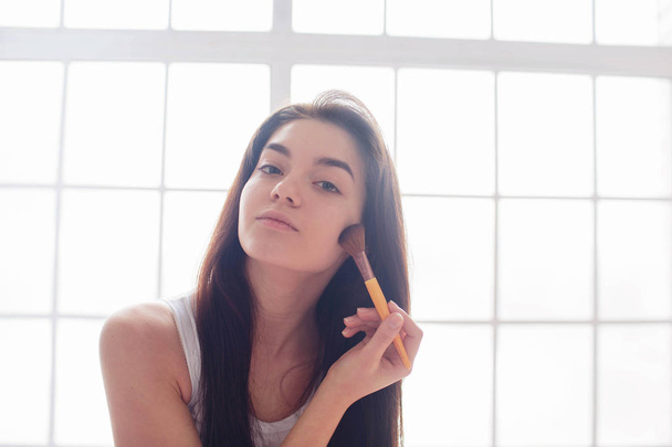 Skin care for a young woman and a morning makeup - 写真・画像