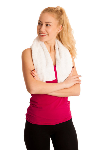 Woman resting after fitness workout with towel arounfd her neck  - Valokuva, kuva