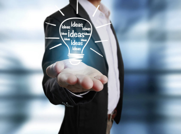  business person holding light bulb  - Photo, Image