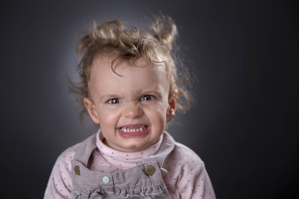 Angry two years girl - Фото, изображение