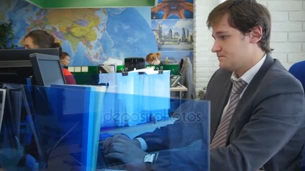 man working on computer in light office - Video, Çekim