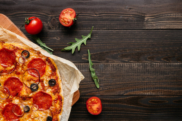 Delisious pepperoni pizza on the wooden table with copy space, top view - Foto, Imagem