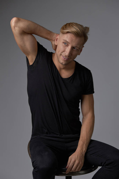Handsome blond young man posing at studio - Foto, imagen