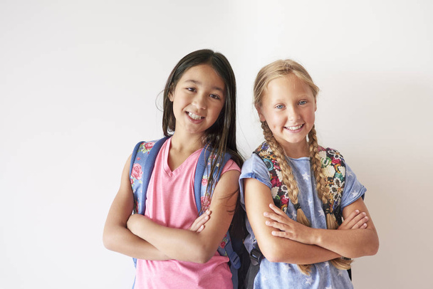 schoolgirls with backpacks looking at camera - Photo, Image