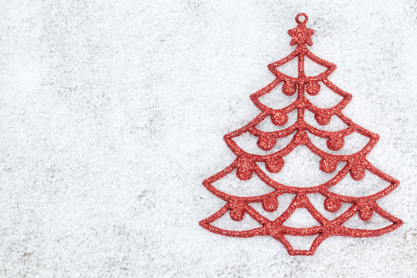 Decorative red Christmas tree on white snow. - Photo, Image