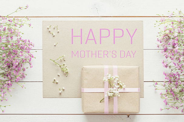 Mother's day background, white wooden table with pink flowers and a present - Fotografie, Obrázek