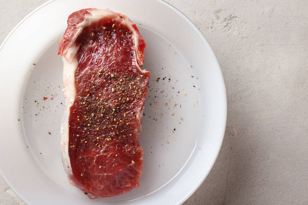 Raw steak with spices - Photo, Image