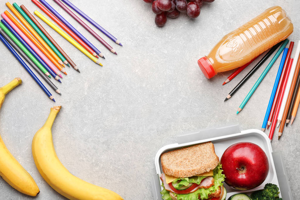 Delicious food and colorful pencils on light textured background - Foto, Imagem