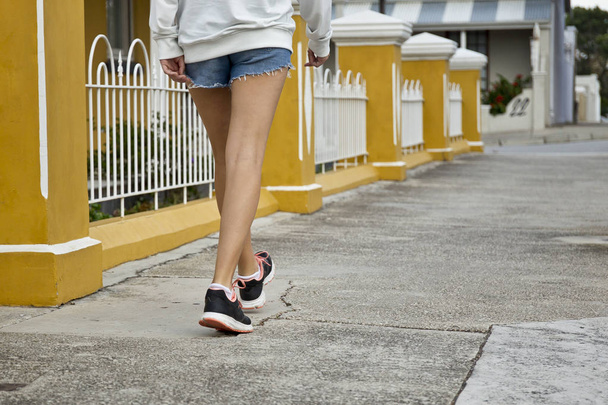 Young woman walking a long a concrete path - Φωτογραφία, εικόνα