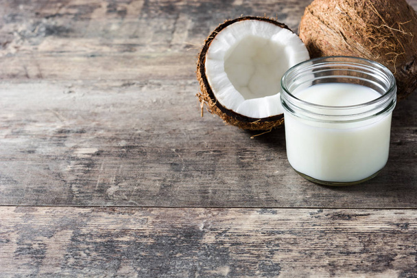 Coconut and coconut milk on wooden table - Fotografie, Obrázek