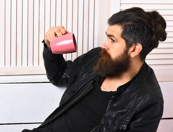 Brutal caucasian hipster holding cup or mug - Photo, Image