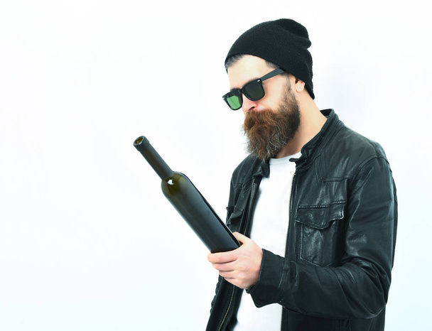 Bearded brutal caucasian hipster holding bottle - Zdjęcie, obraz