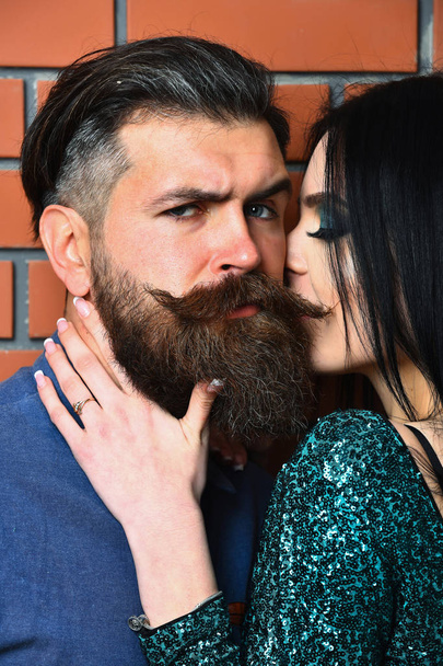 bearded man and pretty sexy woman on brick wall - Фото, изображение