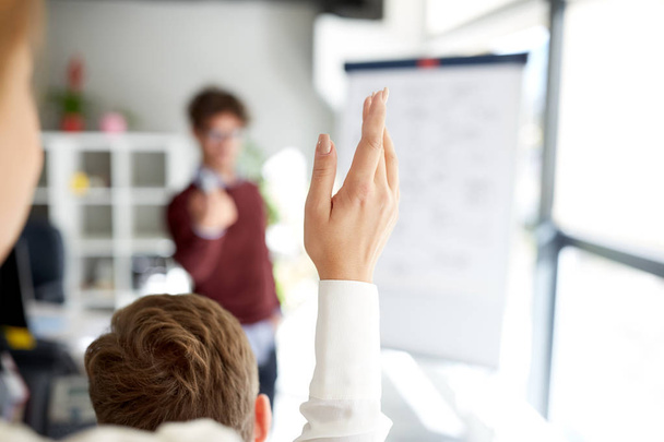 woman raising hand at presentation in office - Zdjęcie, obraz
