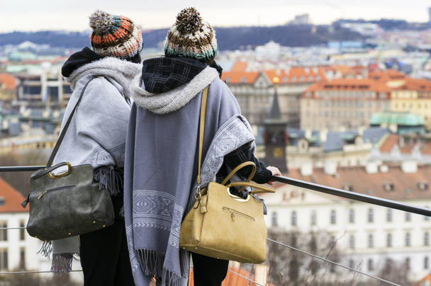 Two young women look at the Prague city from above, from the hill. - Foto, immagini