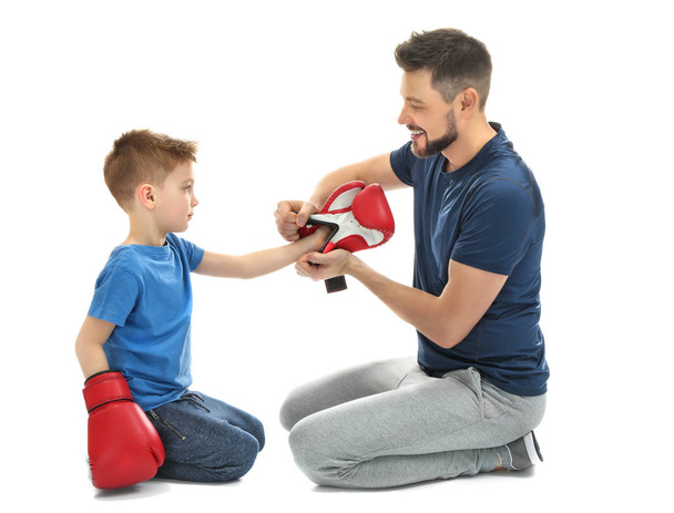 man helping son to put on gloves - Photo, image