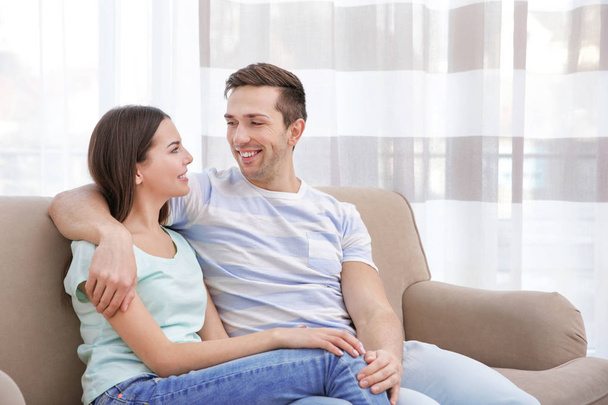 Happy couple resting on couch   - Photo, image