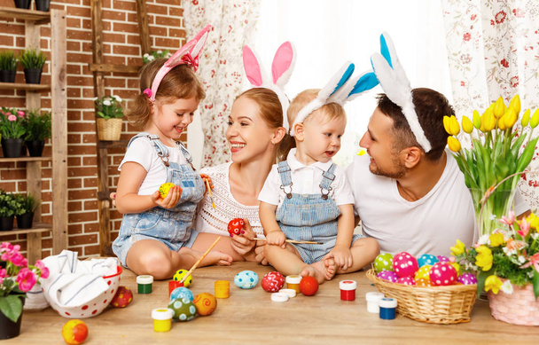 Vrolijk Pasen! familie-moeder, vader en kinderen schilderen eieren voor - Foto, afbeelding