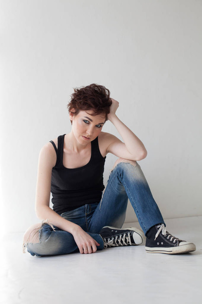 the girl with the short hair sitting on the floor - Photo, Image