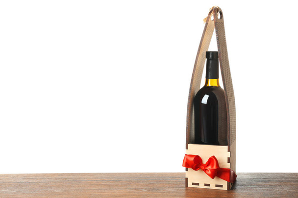 Table with wine bottle in gift box - Foto, imagen