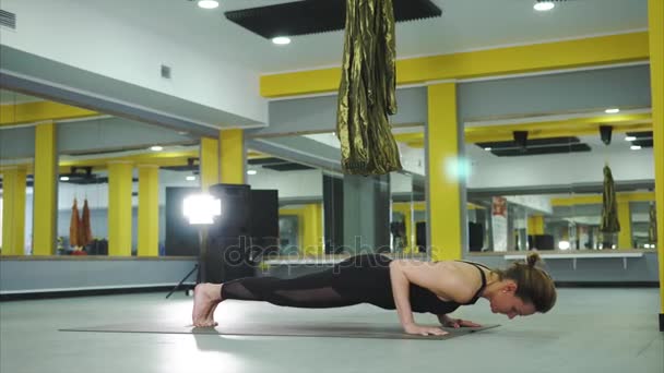Woman rests on the hands and feet, the fingers are set apart in asana poses - Footage, Video