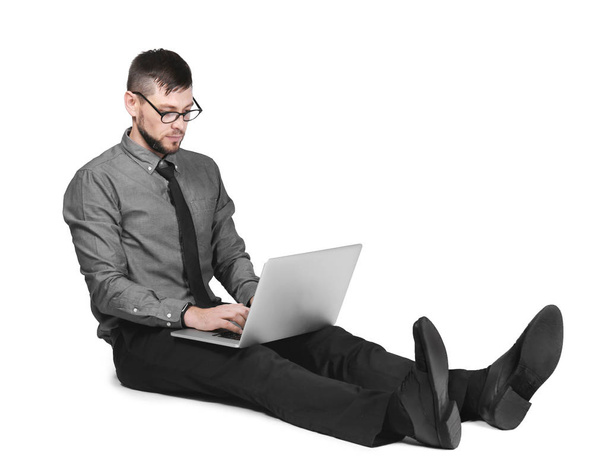 Handsome programmer with laptop on white background - Foto, imagen