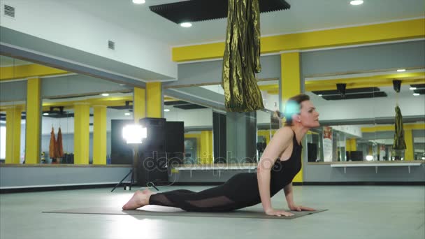 A woman performs an asana, which is called a dog face up - Footage, Video