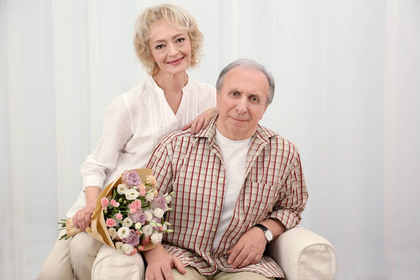 senior couple with flowers  - Fotó, kép