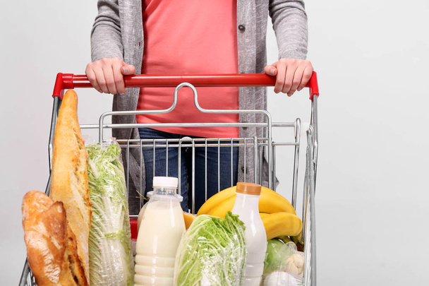 Young woman with full shopping pushcart  - 写真・画像