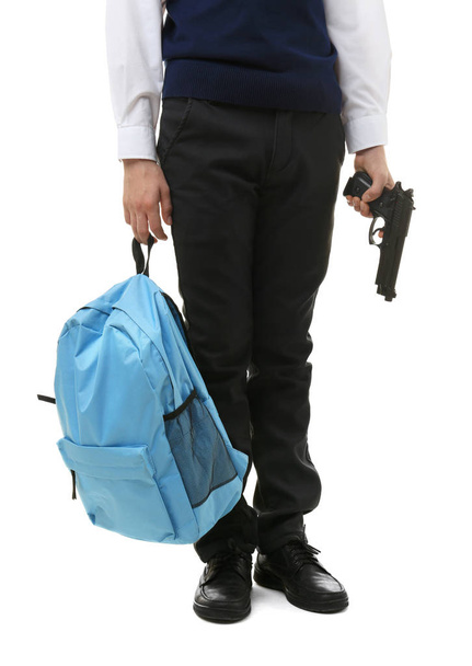 Schoolboy holding backpack and gun - Foto, Imagem
