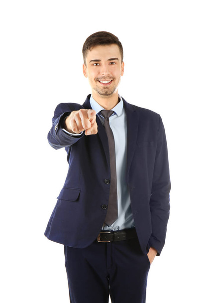 Handsome businessman in elegant suit pointing on white background - Foto, afbeelding