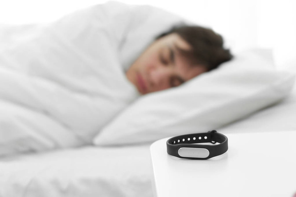 Sleep tracker and blurred resting man on background - Foto, Imagem