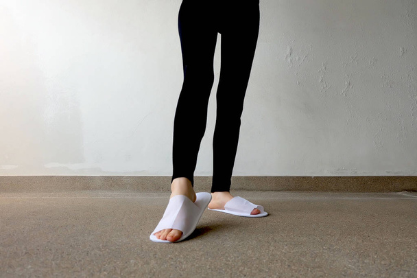 Closeup Photo of From Woman Wearing White Slippers and Black Pants  - Φωτογραφία, εικόνα