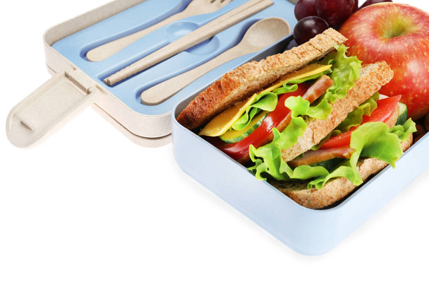 Lunch box with delicious food on white background - Foto, imagen