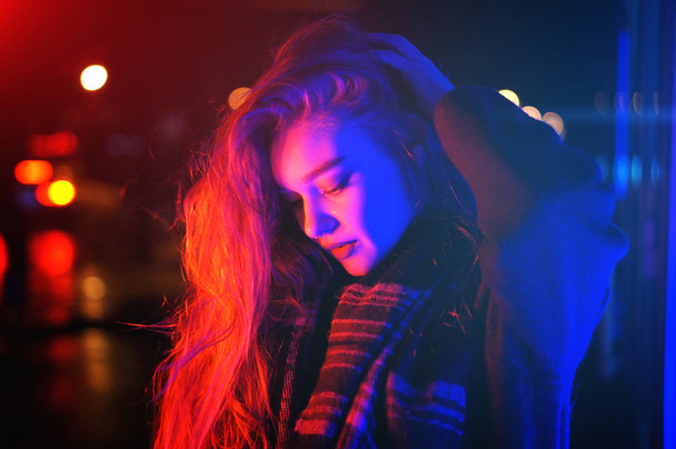Sexy young woman posing over night city dramatic neon background - Φωτογραφία, εικόνα